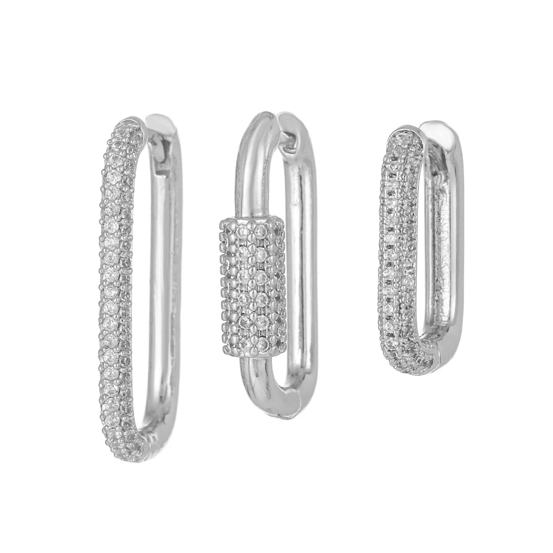 Three geometric ear clips with micro-inlaid zircon stones on copper, showing gold and white gold colour options