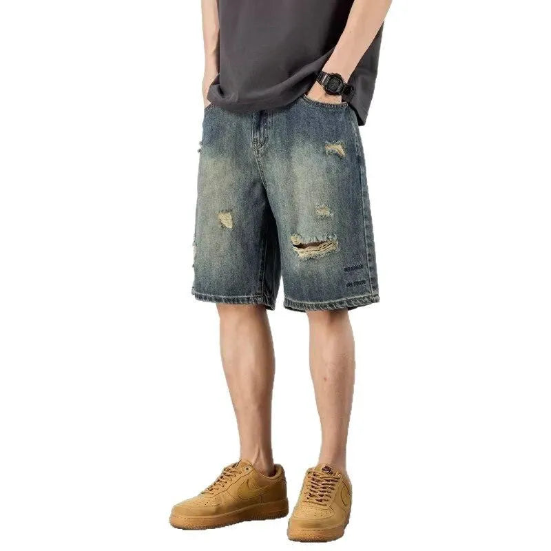 Blue retro loose hole denim shorts for men on a white background