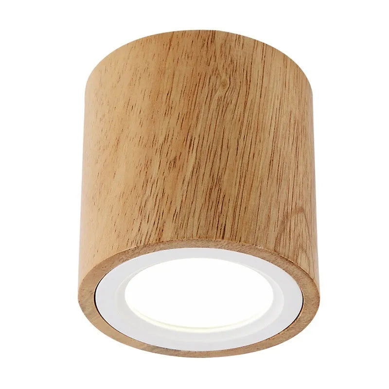 Modern solid wood surface mounted downlight in wood colour, shown in round and square designs for corridor or entrance ceilings.