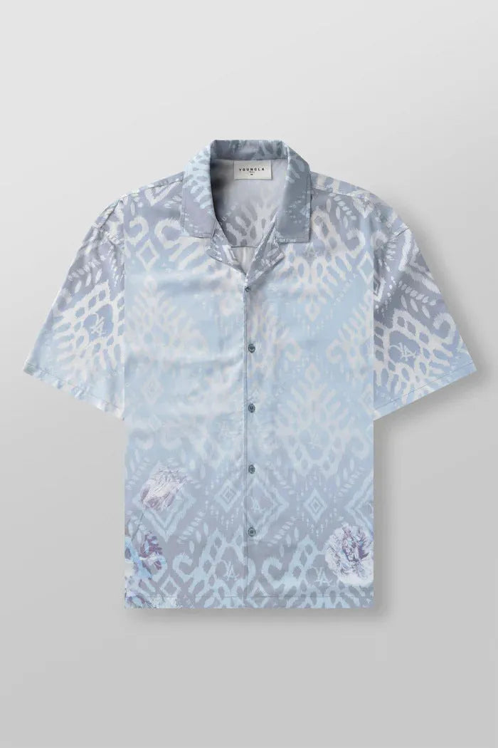 Man wearing a loose, short-sleeve printed cardigan top in a floral pattern.