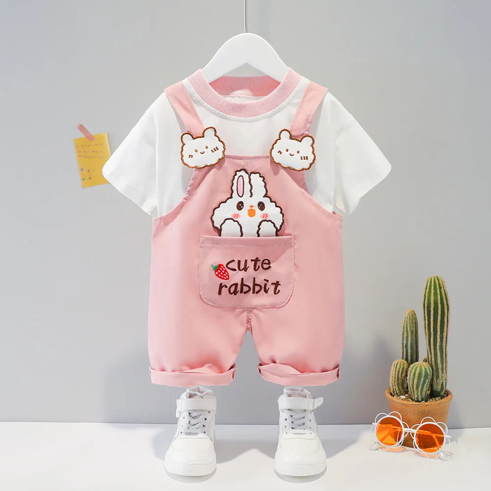 Yellow cartoon short-sleeved overalls for a baby on a hanger, showing the adjustable straps.