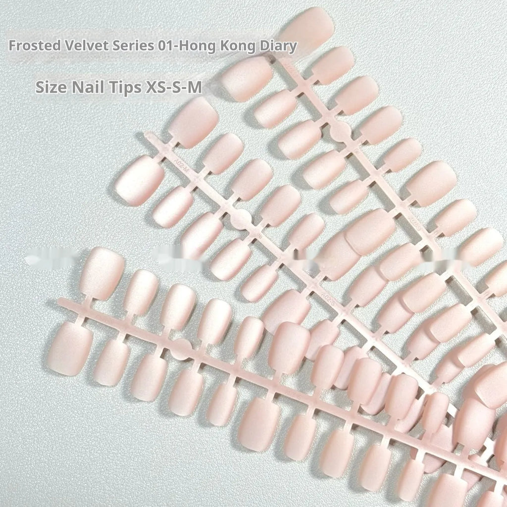 Set of frosted velvet Cat's Eye effect press-on artificial nails in short ladder shapes on a clear background.