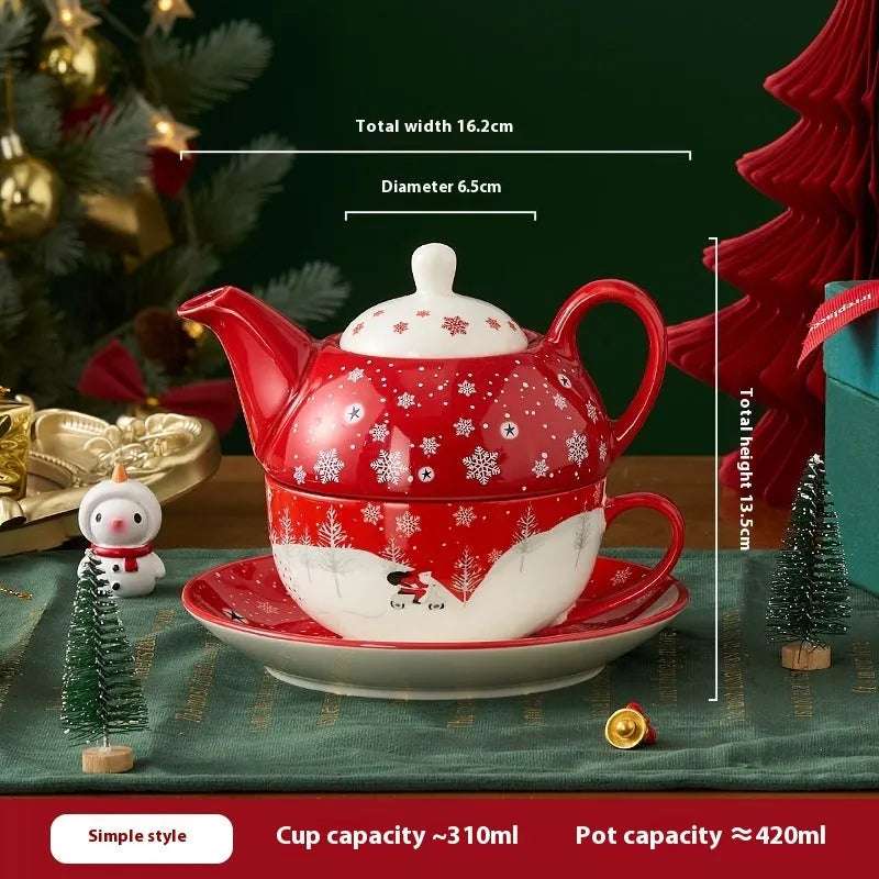 Ceramic gold-plated Christmas teapot set with snowflake design, including pot on dish and cup on dish with spoon, in gift box.