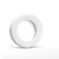 Black USB-rechargeable LED selfie ring light for mobile phone photography on a table.