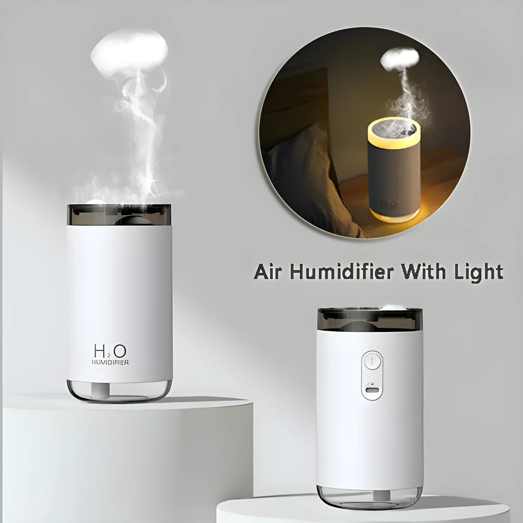 White jellyfish-shaped USB humidifier emitting smoke ring mist with warm night light glow on a table.