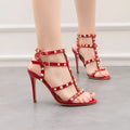 Retro nightclub heels with super high thin heel over 8 cm, artificial PU vamp, rivet detailing, and round toe in black