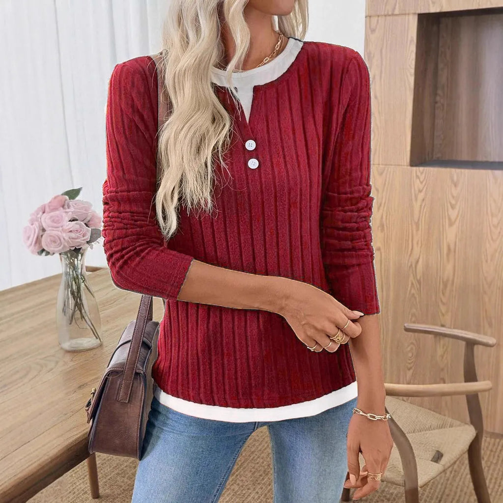 Women's black fake two-piece round neck button pullover sweater with long sleeves on a hanger.