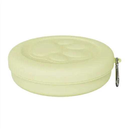 Portable dog food and water bowl with integrated snack box compartments in pink and green colour options.