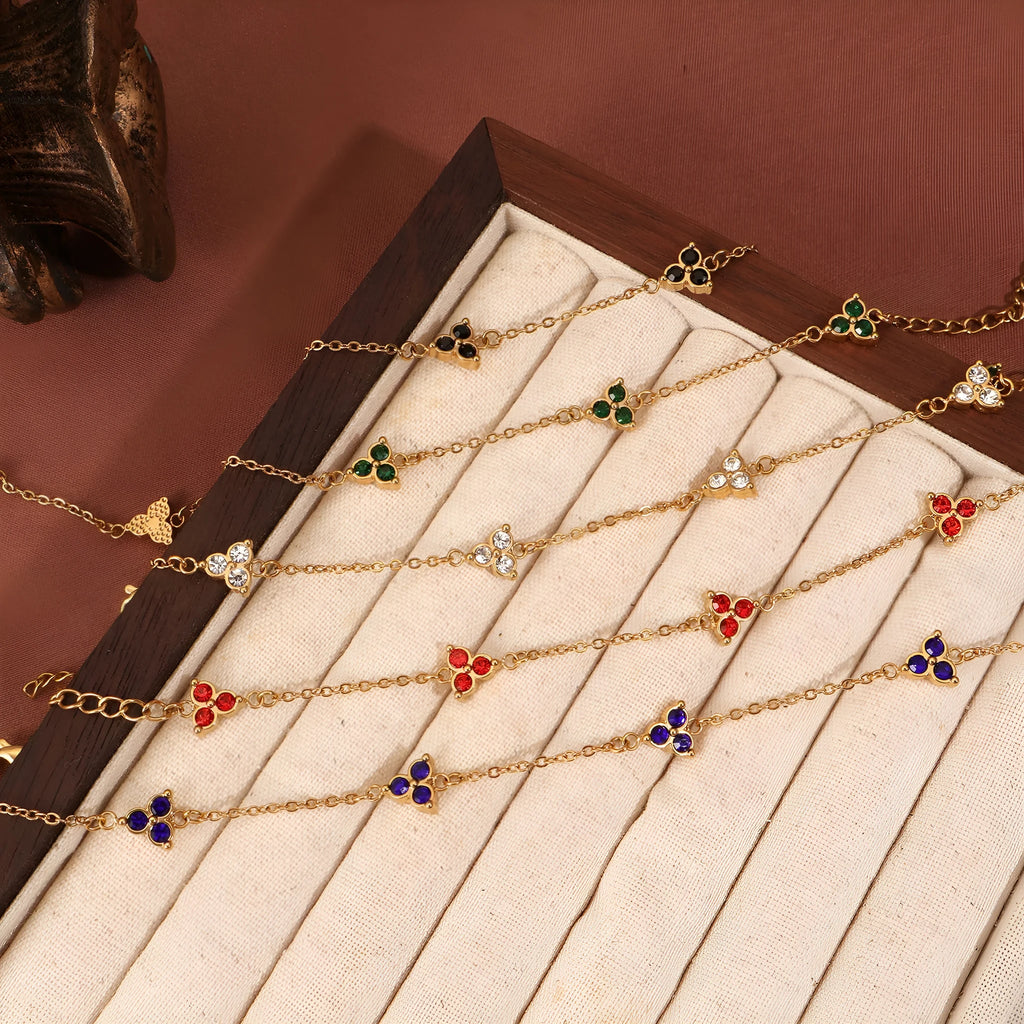 Geometric triangular stainless steel women's bracelet with coloured zircon stones in gold or steel finish.