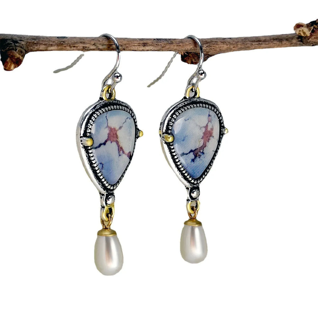 Retro blue Bohemian style drop earrings with geometric metal design, synthetic blue opal and white pearl elements