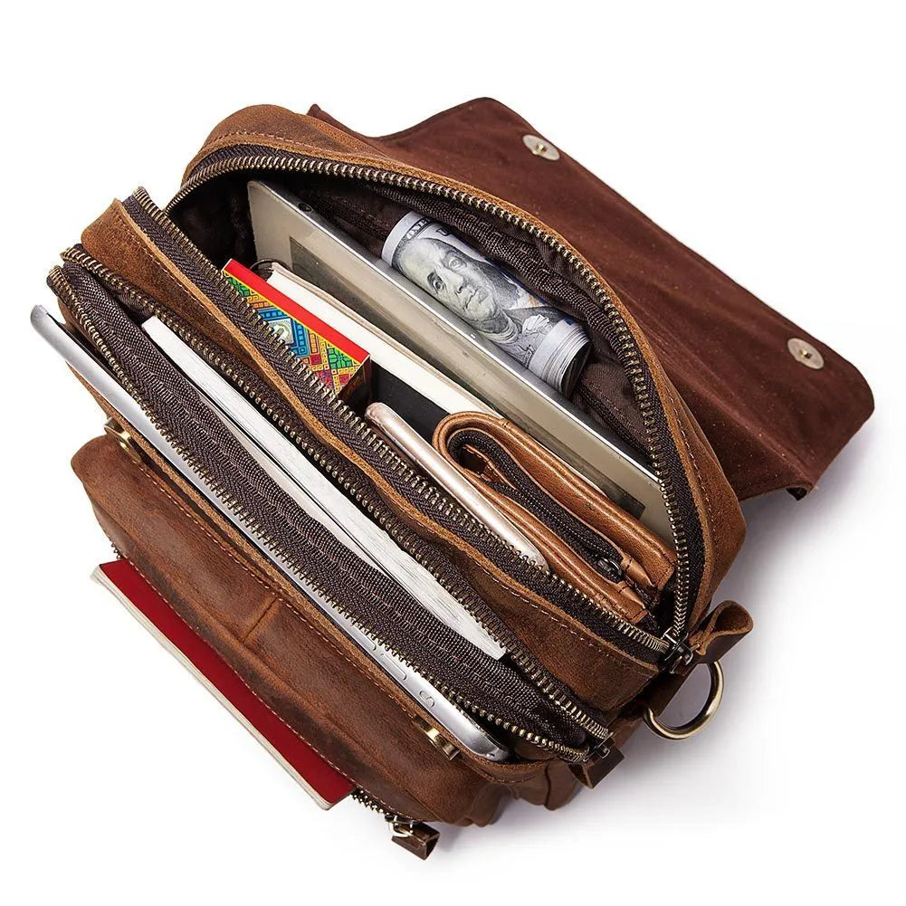 Men's brown leather shoulder bag with zipper buckle closure on soft surface