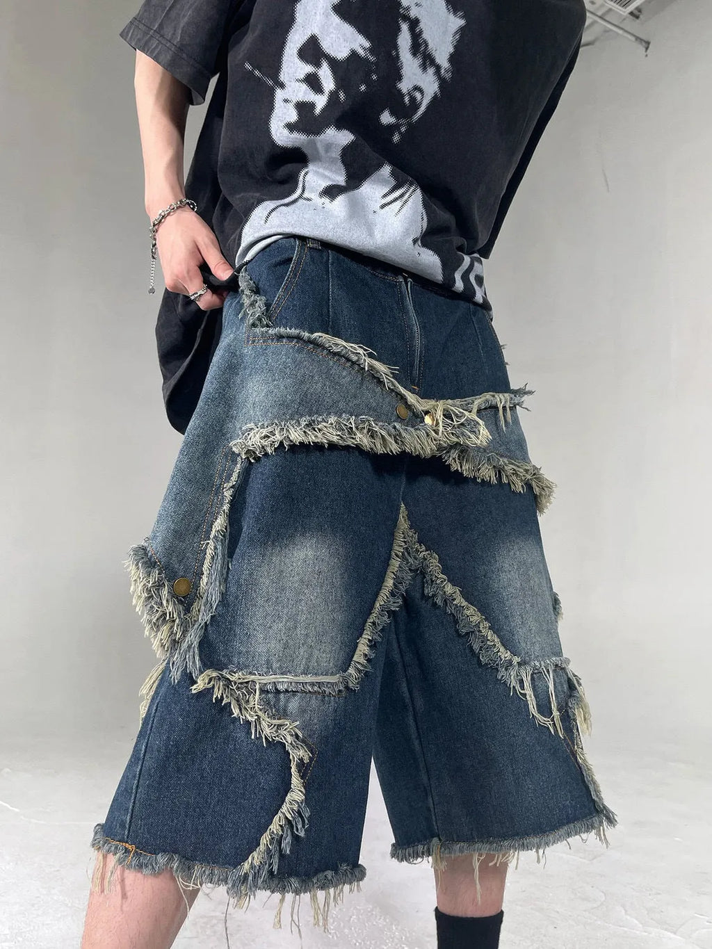 Blue denim shorts with frayed five-pointed star design in loose retro style
