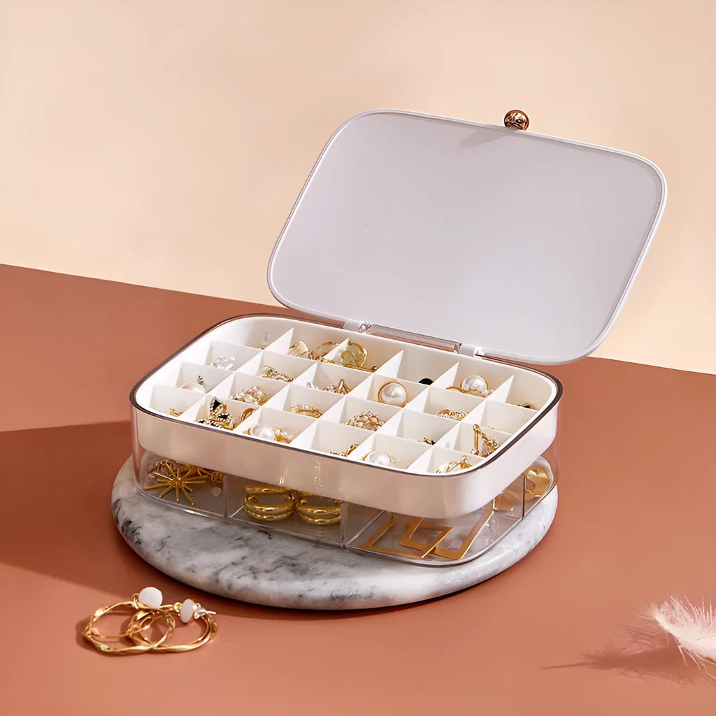 Modern minimalist green jewellery storage box with multi-layer compartments open on a dressing table.