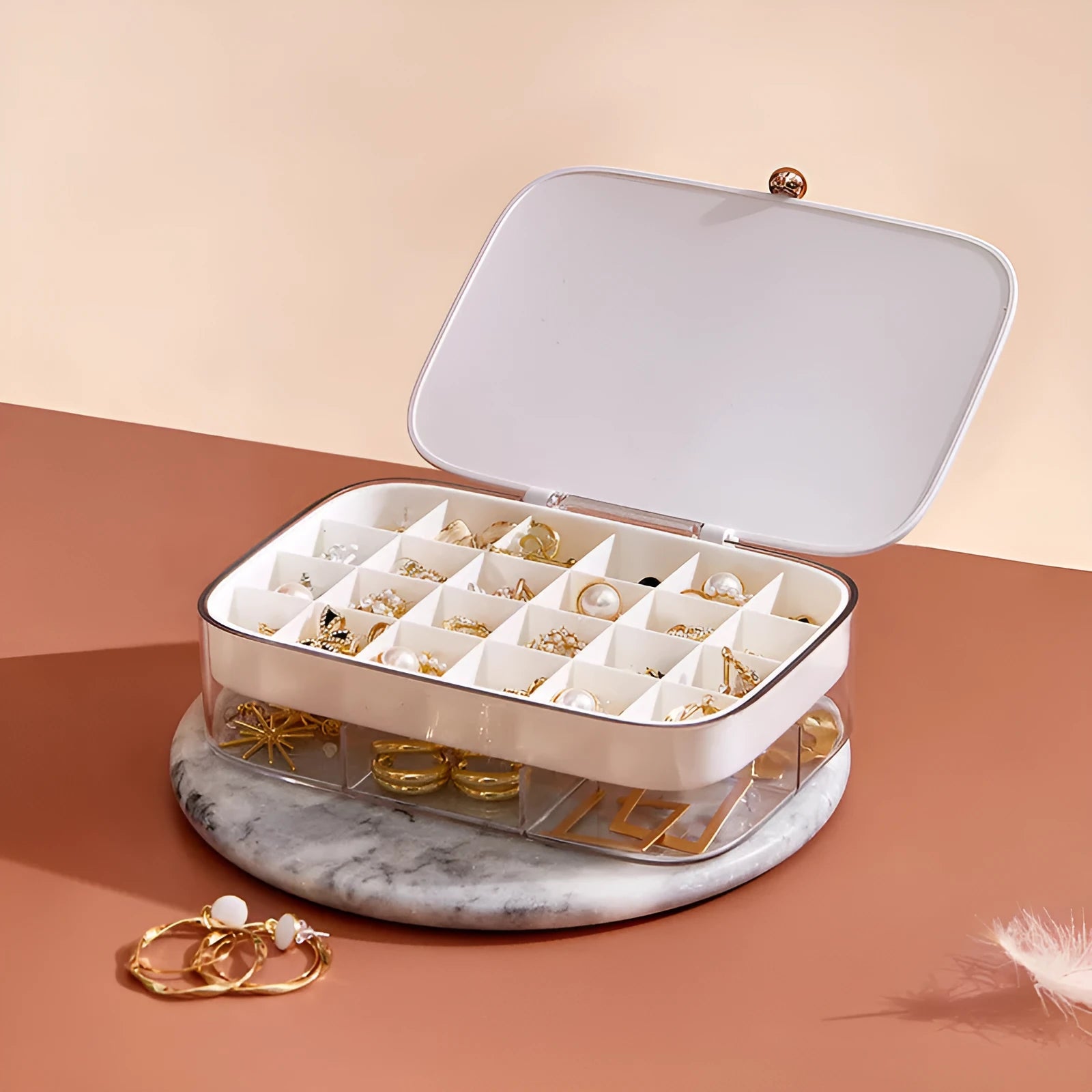 Modern minimalist green jewellery storage box with multi-layer compartments open on a dressing table.