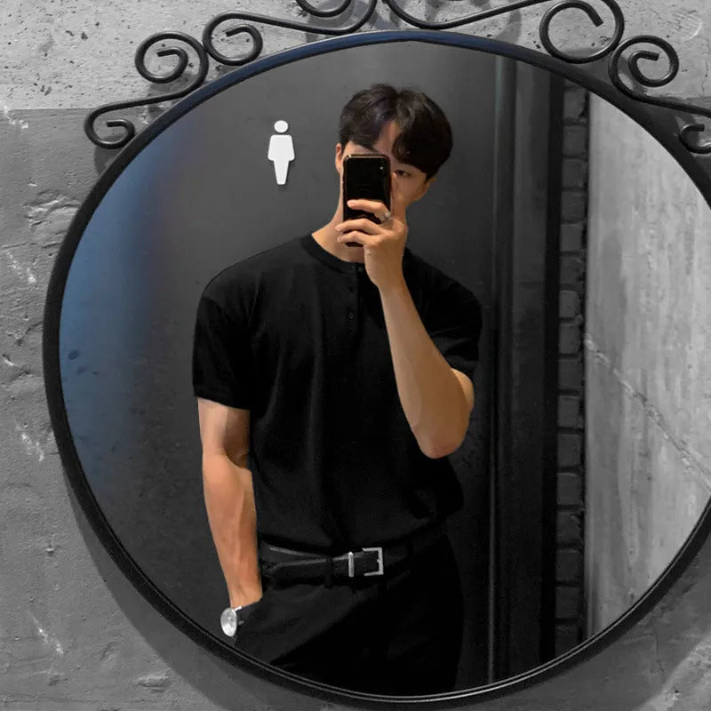Man wearing a slim-fit black short-sleeved ice silk knitted shirt.