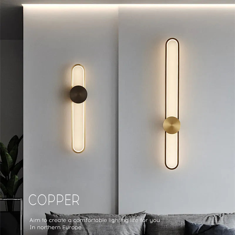 Round modern minimalist wall lamp with iron shade in black or gold finish.