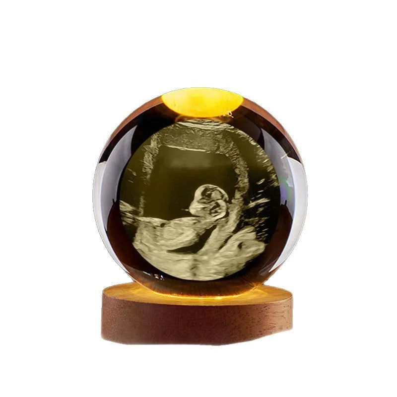 Clear crystal ball night lamp with warm light placed on base, 6cm or 8cm size option available