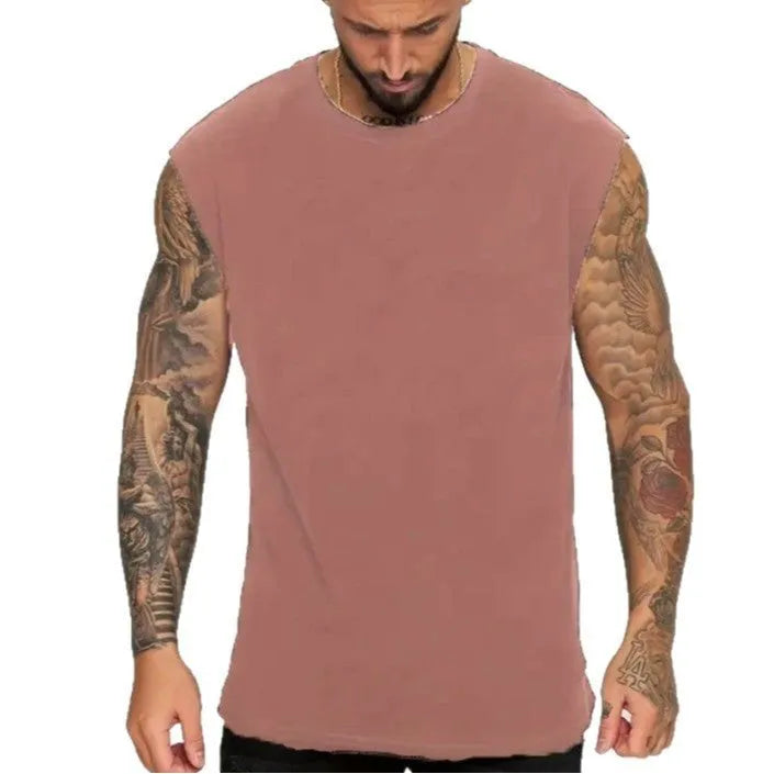 Man wearing a loose solid-colour cotton sleeveless pullover tank top.