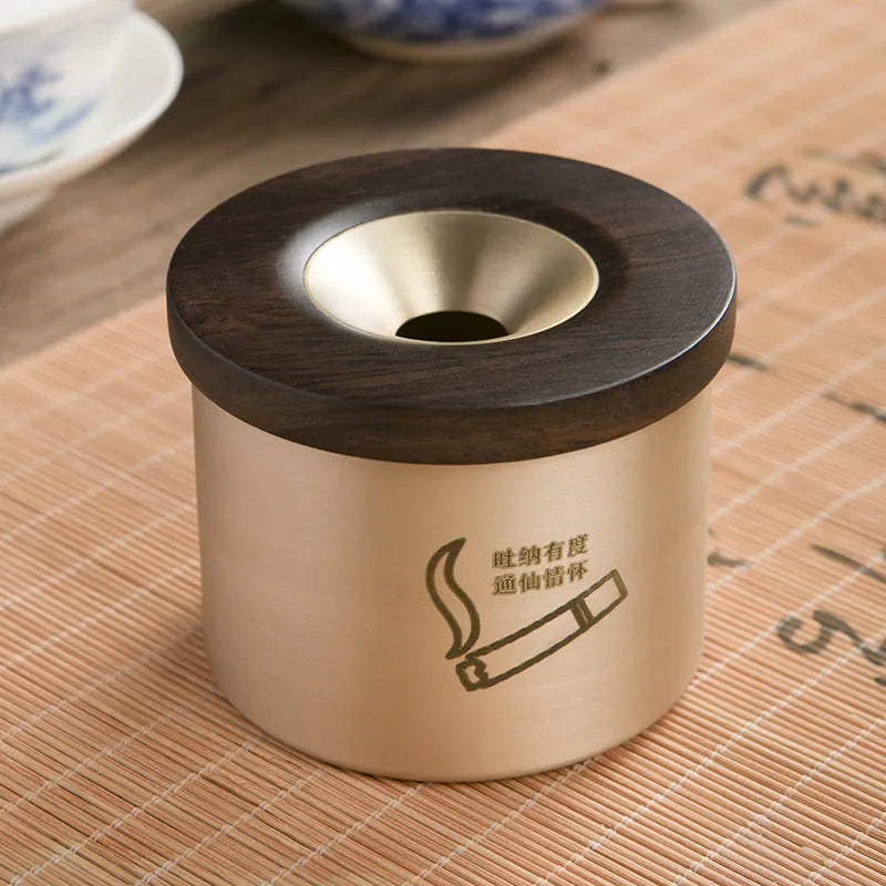 Retro brass-coloured copper ashtray with a wooden lid featuring a central hole