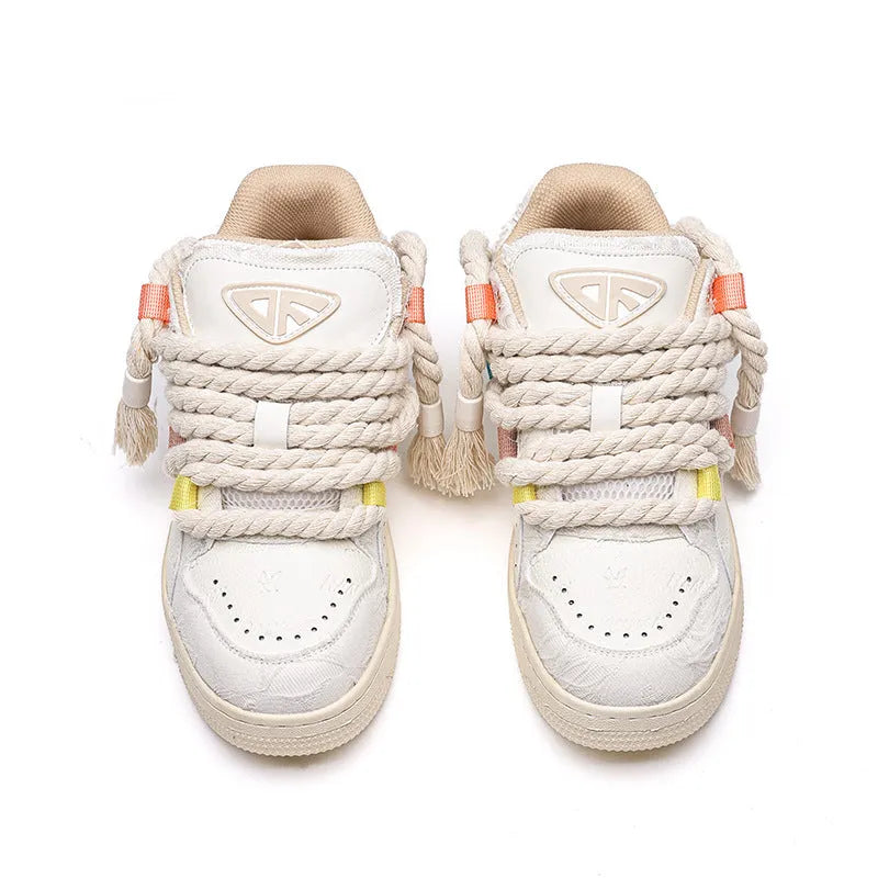 Creamy white Old Damage retro skate shoes with lace-up front, low-top platform heel, and rubber sole.