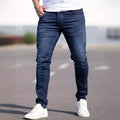 Man wearing dark blue slim-fit stretch cotton jeans with a skinny leg style.