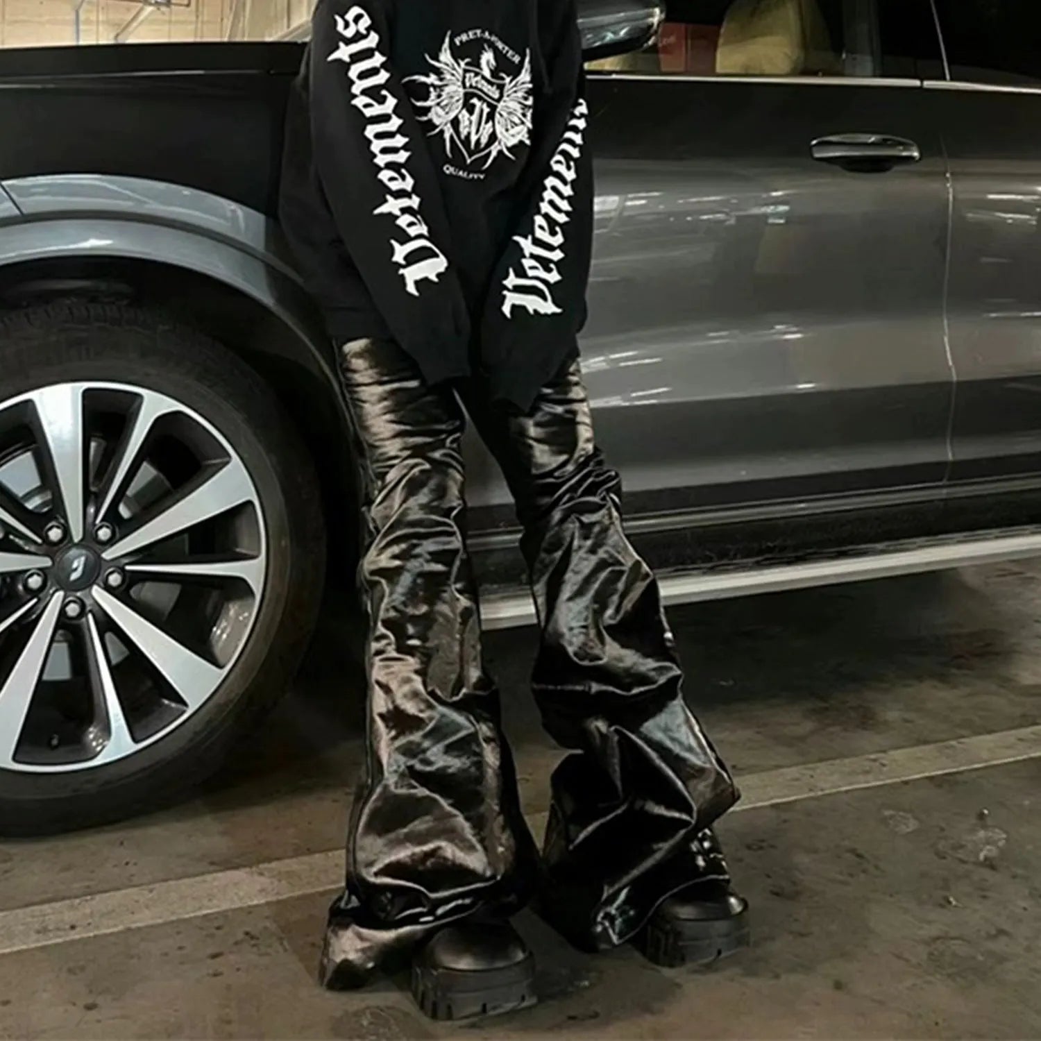 Black women's skinny jeans with a shiny patent leather-like coating and straight-leg fit