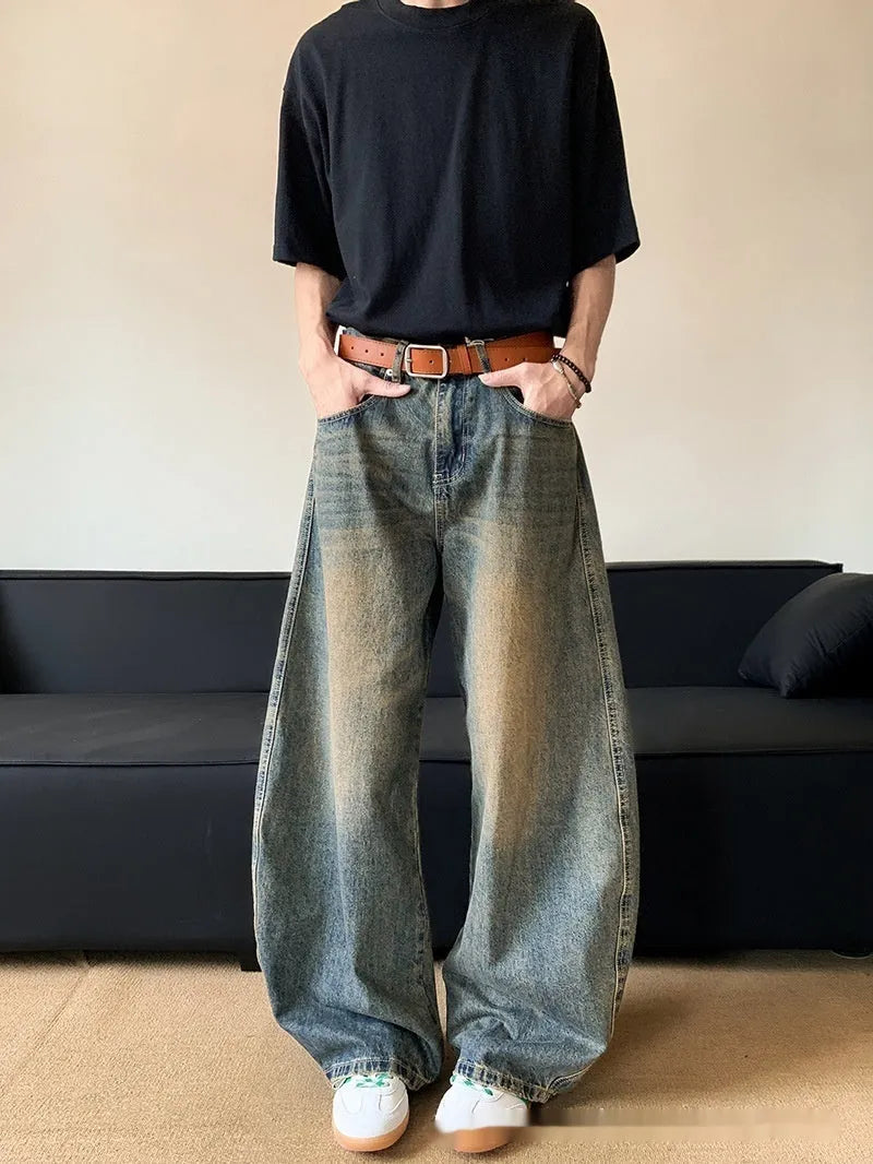 Men's retro blue distressed machete denim jeans with wide-leg silhouette and slim hip fit