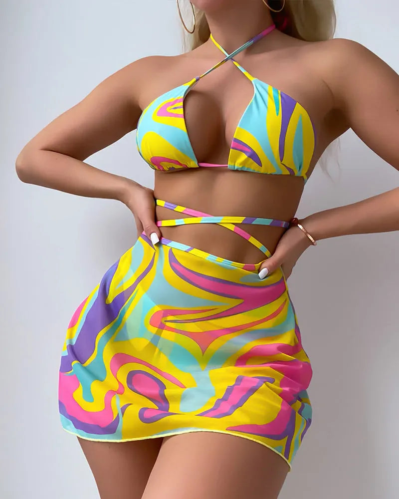 Yellow striped halter neck swimsuit with front lace-up detail, worn with matching skirt and shorts.