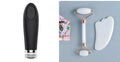 White jade double-headed facial roller and gua sha scraping board set on a plain background.