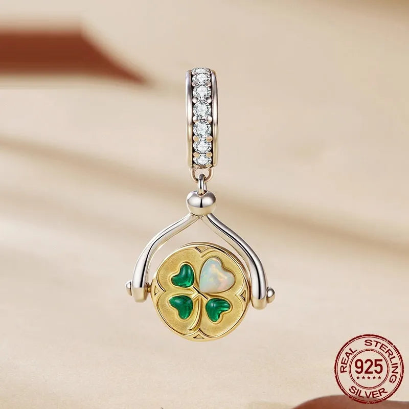 925 sterling silver rotating card pendant with four-leaf clover and wing detail on white background