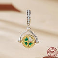 925 sterling silver rotating card pendant with four-leaf clover and wing detail on white background