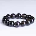 Polished icy obsidian crystal Pi Xiu bracelet with geometric ethnic style on adjustable cord.
