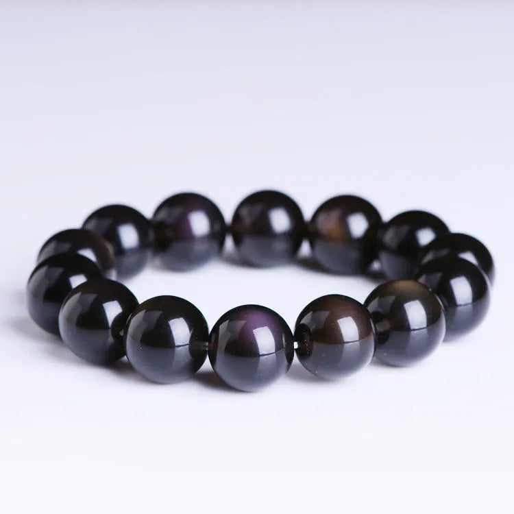 Polished icy obsidian crystal Pi Xiu bracelet with geometric ethnic style on adjustable cord.