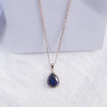 Women's pink rhinestone drop necklace with rose gold electroplated finish and geometric design