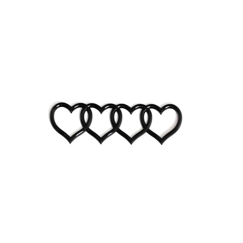 Heart-shaped body sticker with four-ring tail design in electroplated silver colour on a car bumper