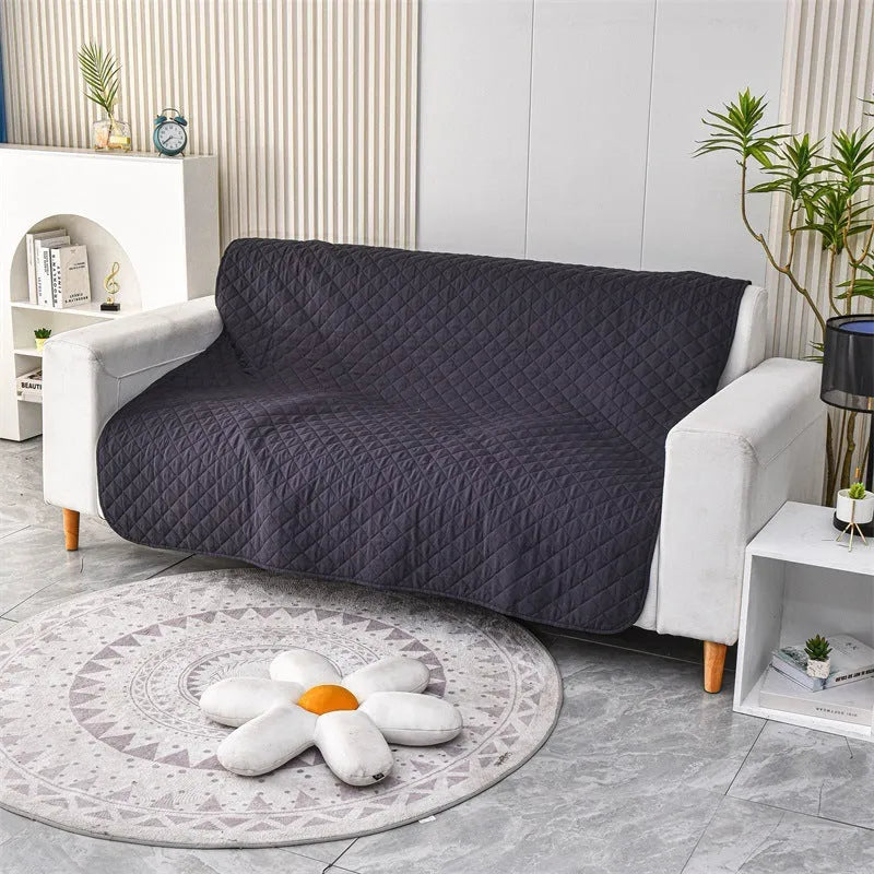 Reversible dog blanket couch cover in grey, laid flat on a sofa