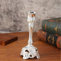 Small retro metal candlestick ornament in gold finish on a wedding table setting