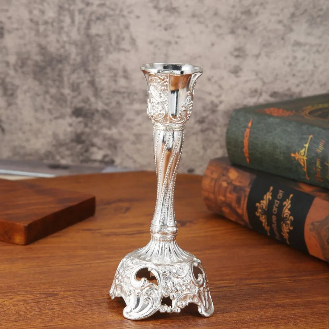 Small retro metal candlestick ornament in gold finish on a wedding table setting