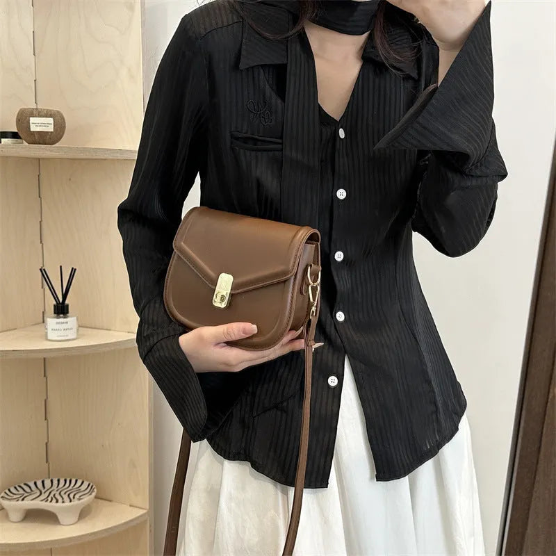 Soft black PU messenger bag with clamshell opening and niche texture, shown open.
