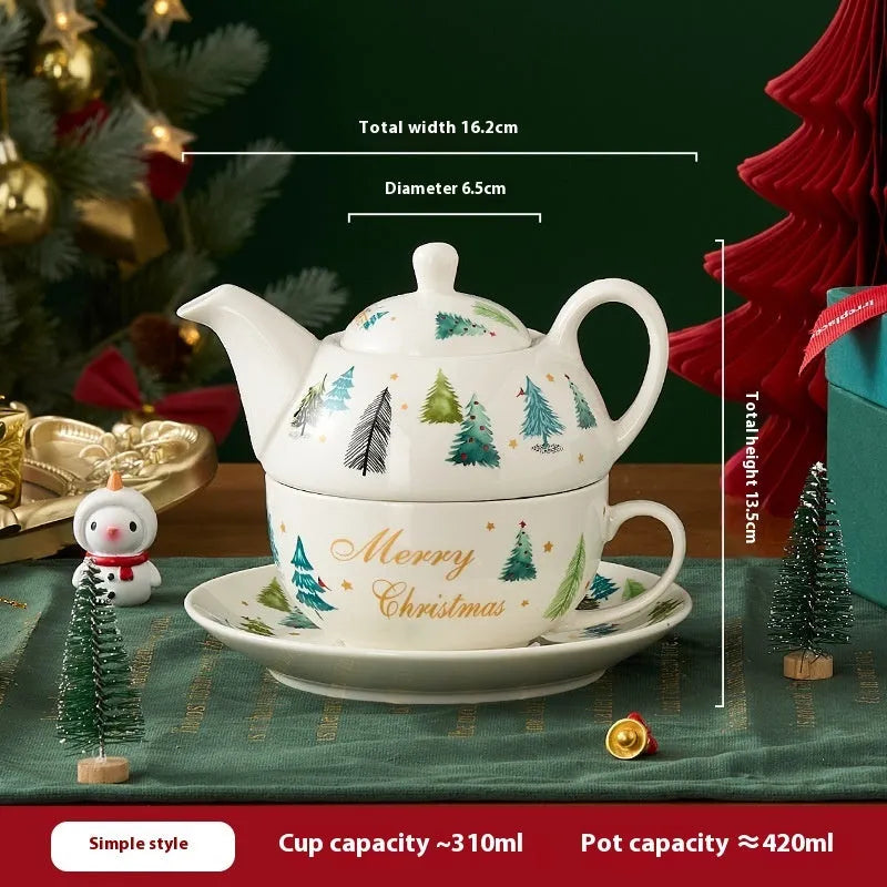 Ceramic gold-plated Christmas teapot set with snowflake design, including pot on dish and cup on dish with spoon, in gift box.