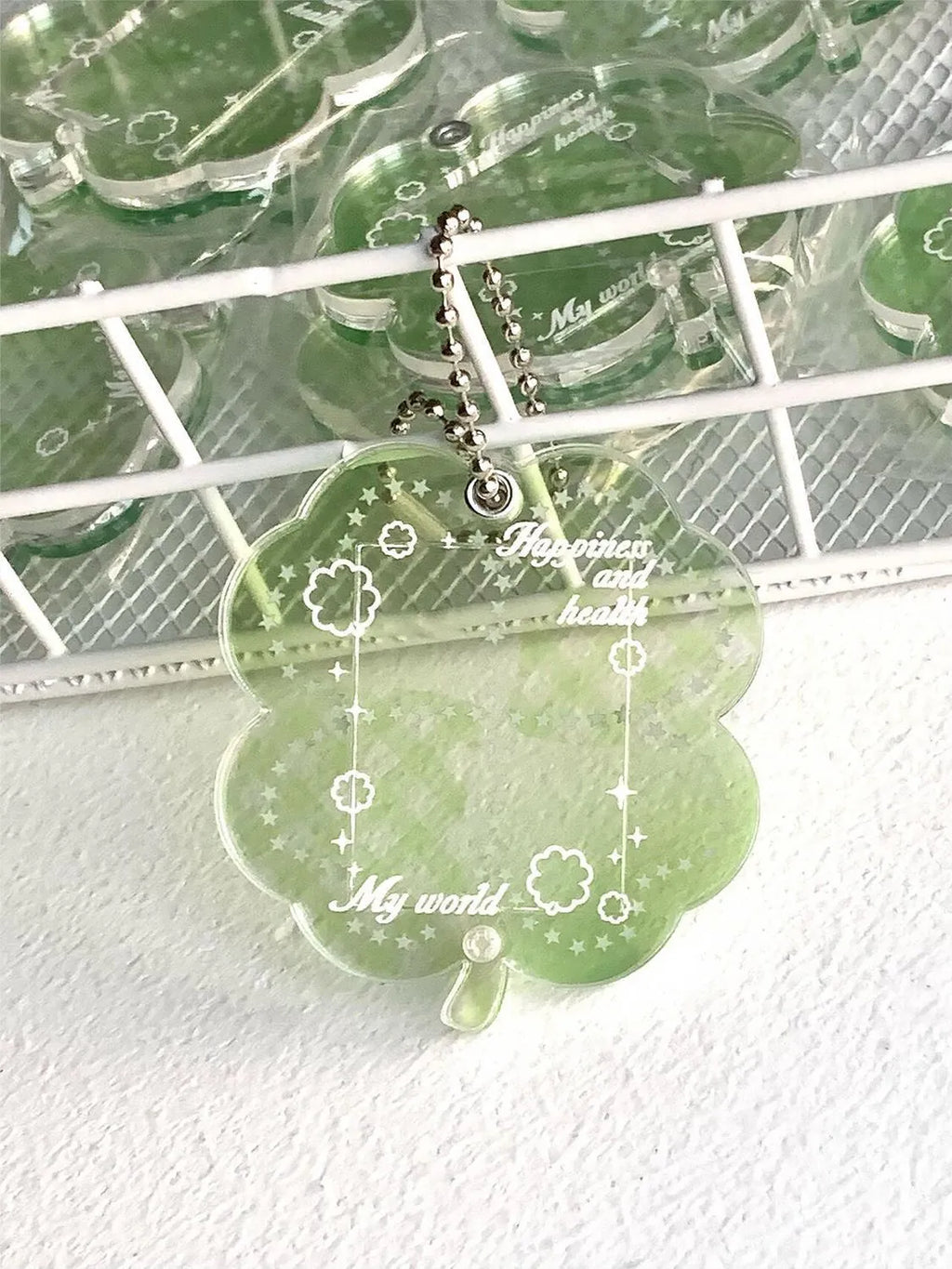 Acrylic four-leaf clover phone pendant keychain in blue, green, or mint green.