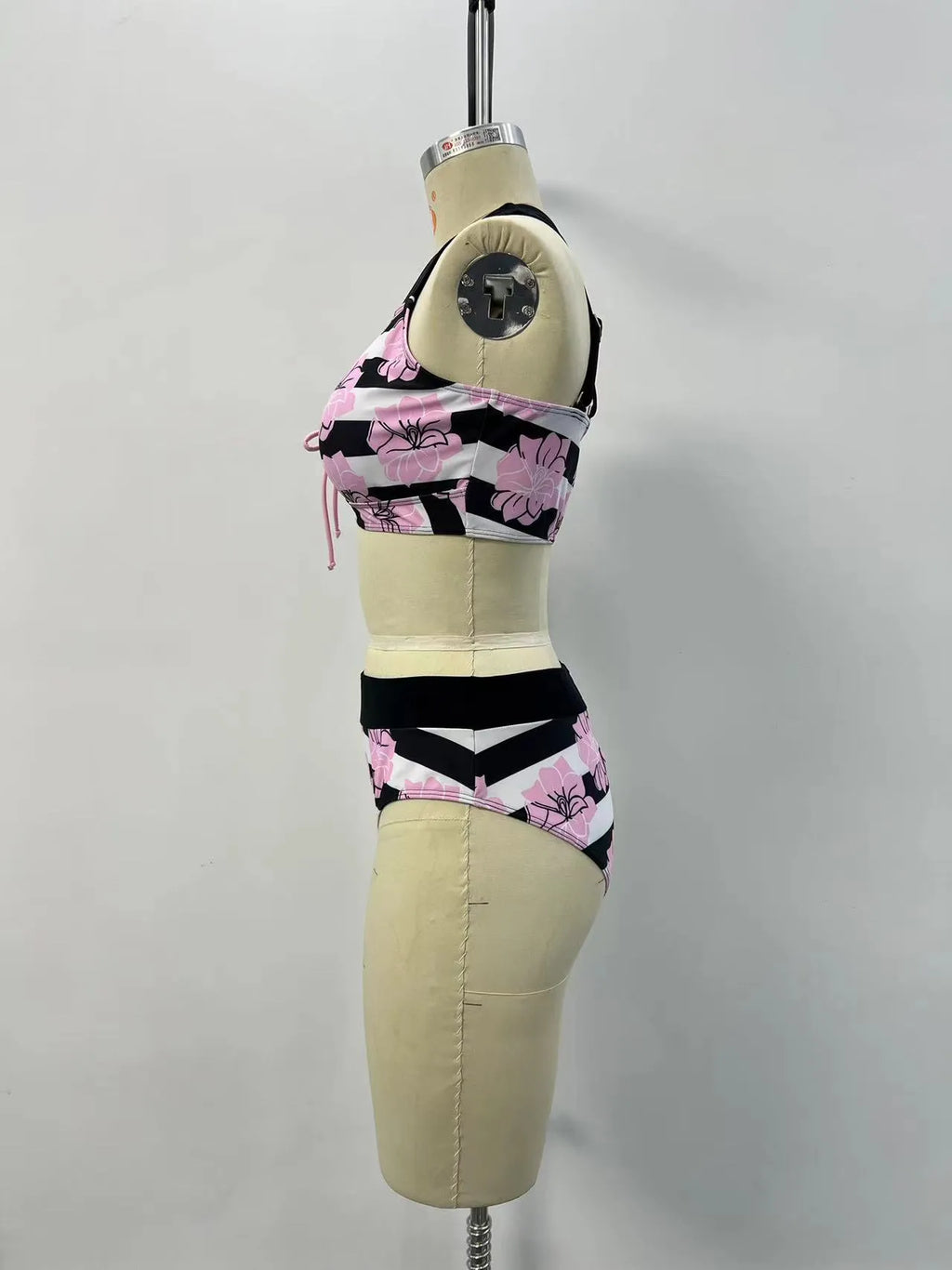 Black women's bikini with printed design, belly coverage and split leg style for swimming.