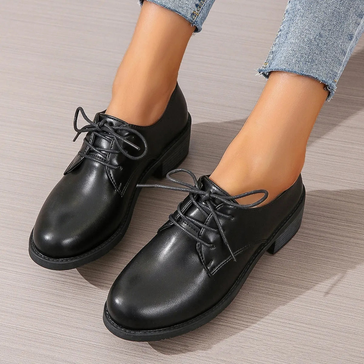 Black women's low-top work shoes with a chunky rubber heel and pointed toe.