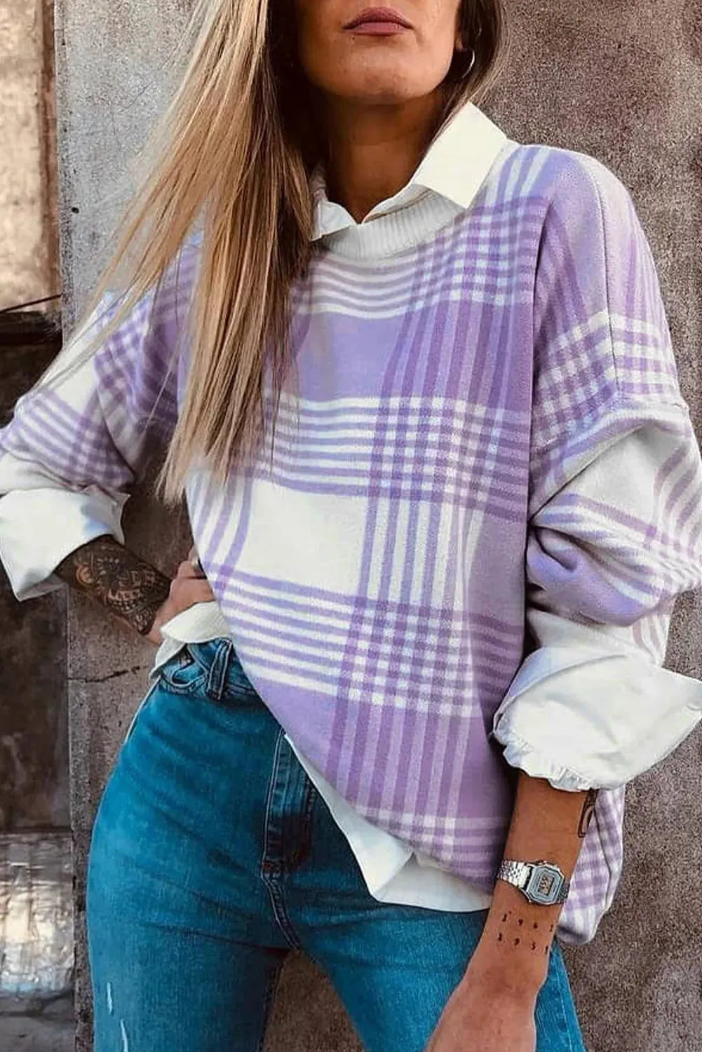 Lilac plaid print loose long sleeve sweater with ribbed cuffs and hem on a hanger.
