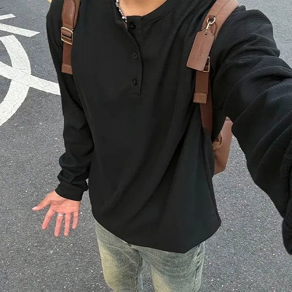 Men's black long-sleeved pullover top with Henry collar in loose fit for daily wear