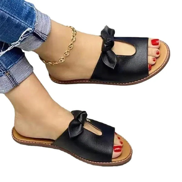 Ladies' black sandals with a fish mouth toe design and a decorative bow on the strap.