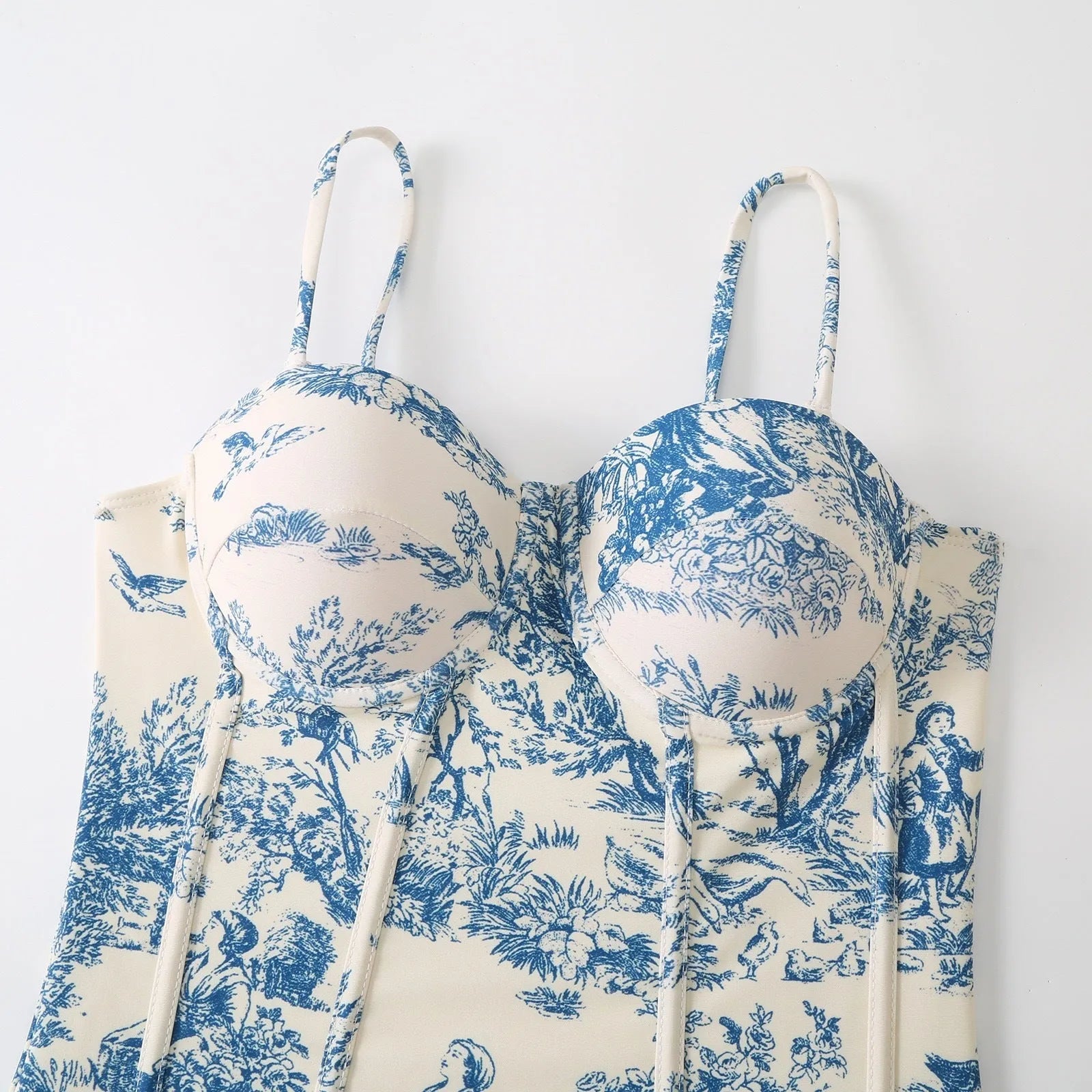 Women's blue one-piece swimsuit set with matching gauze skirt and separate swimsuit piece on size chart