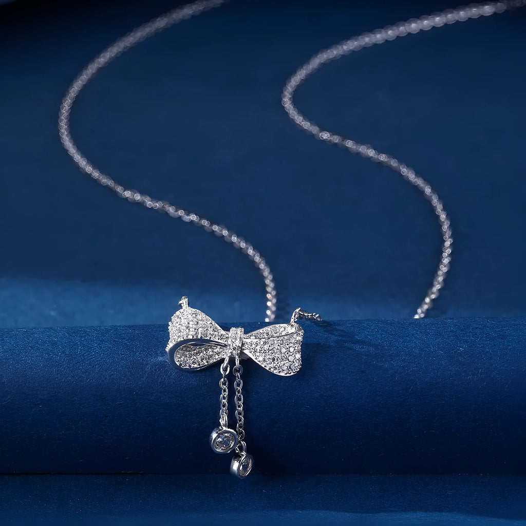 Silver bow pendant necklace on adjustable 40-45cm chain with O-ring closure