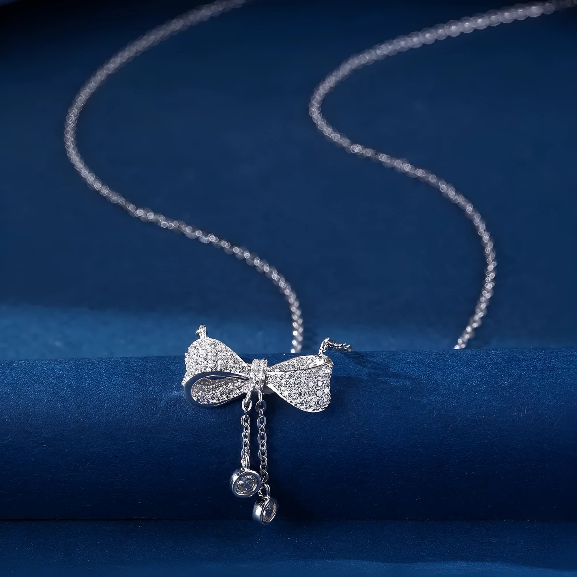 Silver bow pendant necklace on adjustable 40-45cm chain with O-ring closure