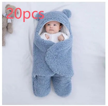 Baby quilted sleeping bag wrapper in cotton blend fabric, shown in grey colour with size tag.